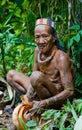 Man Mentawai tribe in the jungle makes his clothes from the tree bark.